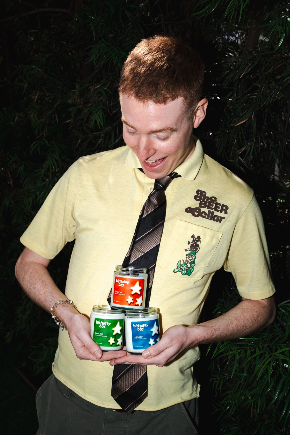 A model holding three Birthday Boy candles