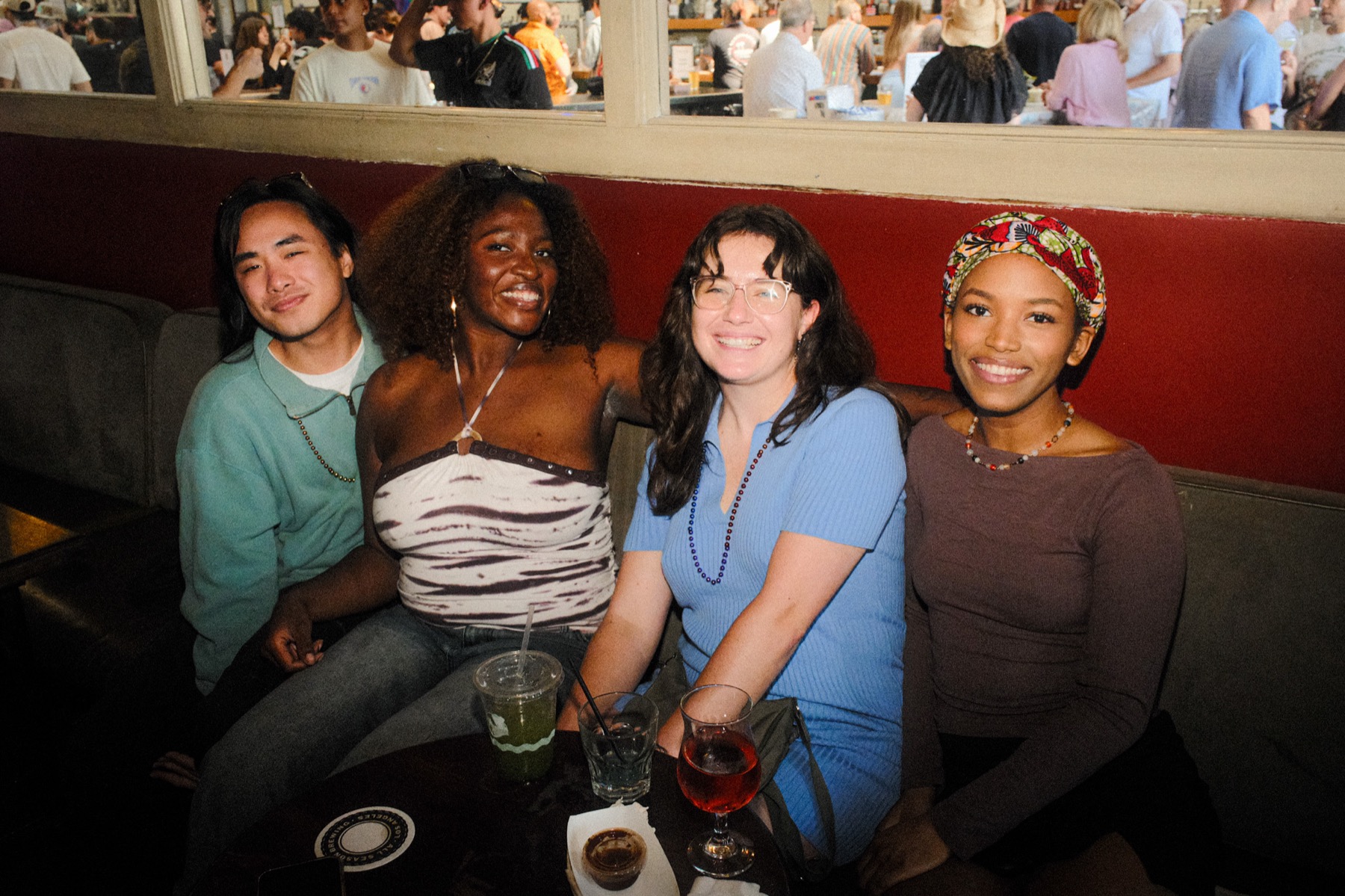 Four friends posing together at the premiere